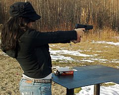 A woman plinking with a Hi-Point pistol in .40 S&W in Alaska.