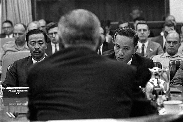 Thiệu and Vice President Nguyễn Cao Kỳ (left) meeting US President Lyndon B. Johnson (with back to camera) in Honolulu (1968)