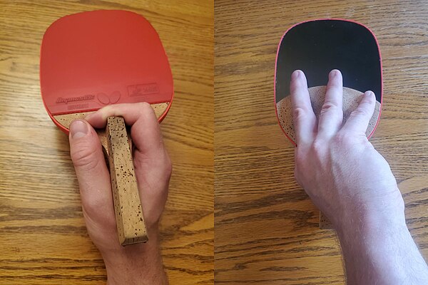 The forehand (red) and back side (black) view of a Traditional Penhold grip. The back side has no rubber and is not used for play, and so the fingers 