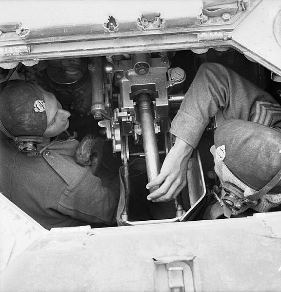 Crew inside a Valentine tank loading the gun.