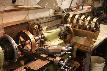 Machining spare trolley pole wheels. The six on the right appear to be finished