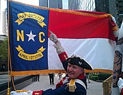 A reenactor points to the May 20th, 1775 date on the North Carolina state flag. Photo taken on May 20, 2011 at the Mecklenburg Declaration commemoration ceremony at Founder's Square, Charlotte, North Carolina.