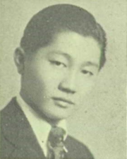 A black and white portrait of a teenage Minoru Yamasaki wearing a suit and tie, facing right