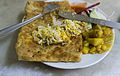 Moglai Porota is a popular deep fried flatbread from West Bengal, India, stuffed with eggs, onions and green chillis accompanied mostly by spicy dry masala potato.