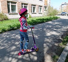 On a scooter in a mask because of COVID-19.jpg