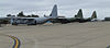 Thee four-engined military aircraft parked on an airfield