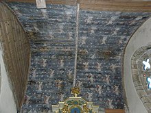 Photograph of a panelled vault painted dark blue, with cherubs holding rosaries