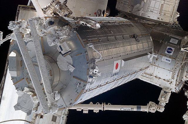 Kibō's pressurised module, two days after its installation, with Discovery in the background