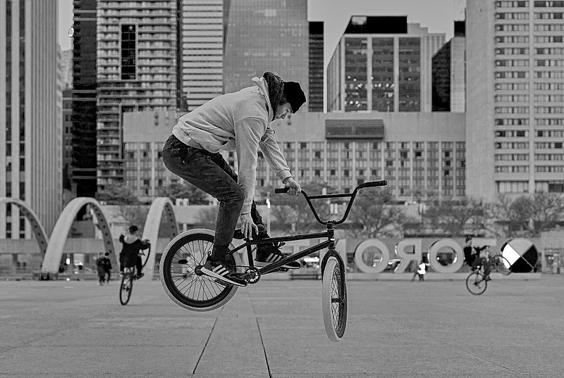 File:Stunt cyclist at Nathan Philips Square 3-B&W.jpg
