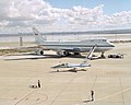 T-38 support aircraft taxies across the ramp in front of NASA's Boeing 747 Shuttle Carrier Aircraft.