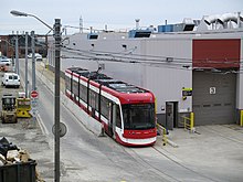 Flexity Outlook 4401 streetcar beside the Harvey Shops TTC LRV 4401 Roof Details.JPG