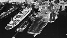 Two ships with the same name. SS America alongside the new aircraft carrier USS America at Newport News, c. 1964. USS America (CVA-66) fitting out c1964.jpg