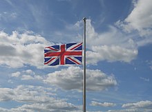 A Union Jack at half-mast after the death of Elizabeth II in September 2022 Union Jack at half mast, Island Harbour marina, Isle of Wight, England (2).jpg