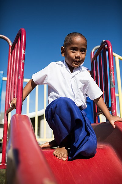 File:A young boy prepares to go down the slippery slide at the Maamatoa Kindergarten in Vaololoa a suburb of the capital Nukuʻalofa. (10664379925).jpg