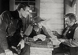 Scene from 1946 Western Abilene Town with actors (from left) Randolph Scott, Wilkerson, and Edgar Buchanan