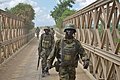 African Union soldiers, as part of the Ugandan contingent of AMISOM, conduct a patrol on April 29 through the town of Qoryooley, Somalia, just over (13894467038).jpg