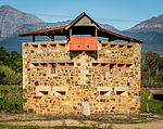 Some of the historical monuments in the Berg River Valley link the history of the area with that of the far interior of the country. This is especially true of the blockhouse on the farm Versailles just north of Welling ton railway station. It guarded the railway bridge over the Berg River and is reached from the road to Hermon. Anglo-Boer War Block House.jpg