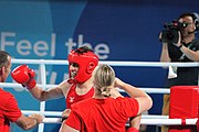 Deutsch: Boxen bei den Olympischen Jugendspielen 2018 Tag 12, 18. Oktober 2018 - Kampf um Bronze im Leichten Weltergewicht Jungen – Hassan Azim (Großbritannien, rot) schlägt Mohammed Boulaouja (Marokko, blau) RSC; Ringrichter ist Wulfren Olivares Peréz (Kolumbien). English: Boxing at the 2018 Summer Youth Olympics on 18 October 2018 – Bronze Medail Match Light Welterweight Boys - Hassan Azim (Great Britain, red) beats Mohammed Boulaouja (Morocco, blue) RSC; Referee is Wulfren Olivares Peréz (Columbia). Español: Boxeo en los Juegos Olímpicos Juveniles de Verano de 2018 en 18 de octubre de 2018 - Medalla de bronce de los hombres ligeros de peso welter: Hassan Azim (Gran Bretaña, rojo) vence a Mohammed Boulaouja (Marruecos, azul) RSC; El árbitro es Wulfren Olivares Peréz (Colombia).