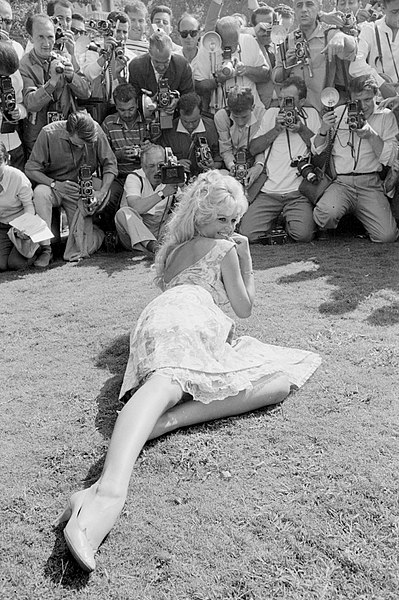 Bardot posing for a crowd of photographers during the 1958 Venice Film Festival