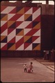 CHILDREN PLAYING BENEATH EYE-CATCHING MURAL IN A SMALL CITY PARK ON THE CORNER OF 29TH STREET AND SECOND AVENUE IN... - NARA - 551726.tif