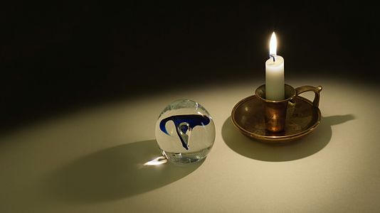 Candle light projected through a glass orb