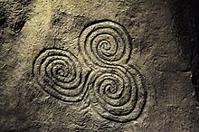 5,000 year-old triskelion on an orthostat at Newgrange Celtic spiral.jpg
