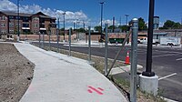 Construction of Arvada Ridge station, sidewalk fence.jpg