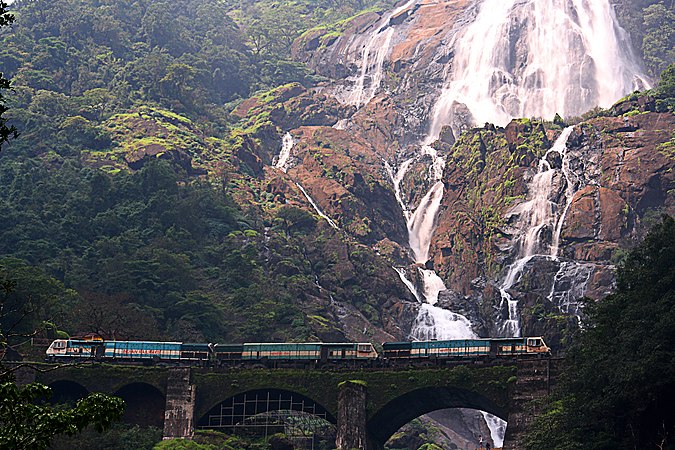 Train passing next to the Dudhsagar Falls.