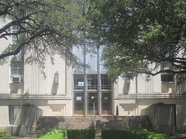 Glimpse of Falls County Courthouse, shaded by large trees