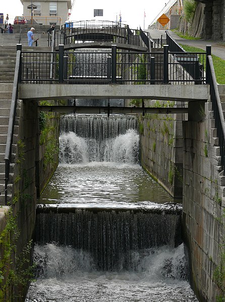 Original northern five step lock structure crossing the Niagara Escarpment at Lockport now without gates and used as a cascade for excess water. Doubl