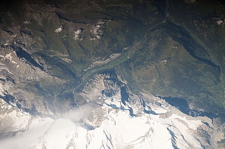 A valley, a mountain region in Switzerland and a shadow of a mountain (Eiger, view)