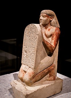 Kneeling portrait statue of Amenemhat holding a stele with an inscription; circa 1500 BC; limestone; Egyptian Museum of Berlin (Germany)