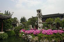 In the Lingering Garden in Suzhou, flowers provide a contrast with a scholar stone chosen to represent Mount Tiantai, one of the founding centers of Chinese Buddhism. Liuyuan.jpg