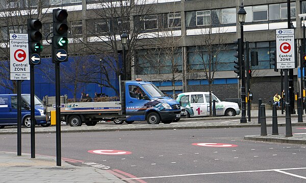 Street markings and signs with the white-on-red C alert drivers entering the charge zone at Tower Hill.