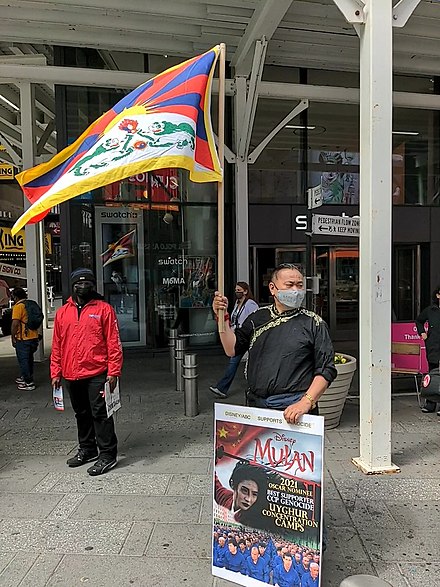 Tibetans protesting the film in Times Square. Protestors held placards criticizing the film's Oscar nominations and accusing Disney of ignoring human rights violations in Xinjiang.