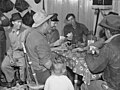 Marion Post Wolcott. Spanish muskrat trappers drinking wine and playing "cache," a form of poker, in their camp in the marshes. Delacroix Island, St. Bernard Parish, Louisiana. January, 1941. And also [4]