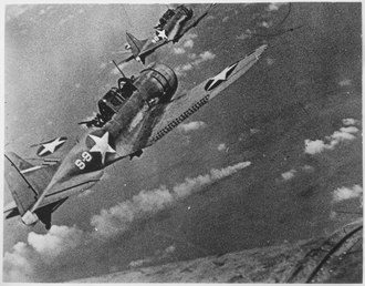 American Douglas SBD Dauntless dive-bomber aircraft attacking the Japanese cruiser Mikuma during the Battle of Midway in June 1942 Navy fighters during the attack on the Japanese fleet off Midway, June 4th to 6th 1942. In the center is visible a... - NARA - 520591.tif