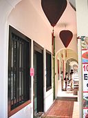 Corridor with Oso on the left, with 2 red lanterns hung above its doorway.