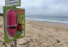 An NSRI Pink Buoy at a beach with its post and signage. Pink Buoy 1.jpg