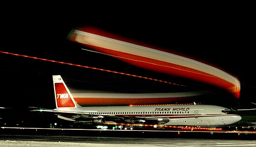 A classical jetliner departs the Los Angeles Airport in the dark. Here, it was just pushed back from the gate.
