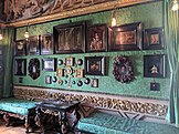 View of one wall in the Green Closet with miniature paintings and furniture