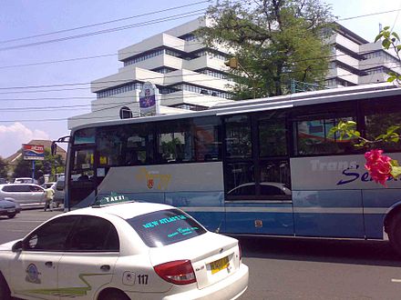A blue-grey TransSemarang bus Koridor I passing Jl Pemuda near the Balai Kota