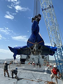 The recovered aircraft is loaded aboard USNS Mendonca (T-AKR-303) at the Port of Augusta, Sicily, 16 August 2022 USNS Mendonca Transports Recovered Navy FA-18E Aircraft to the United States Image 1 of 2.jpg