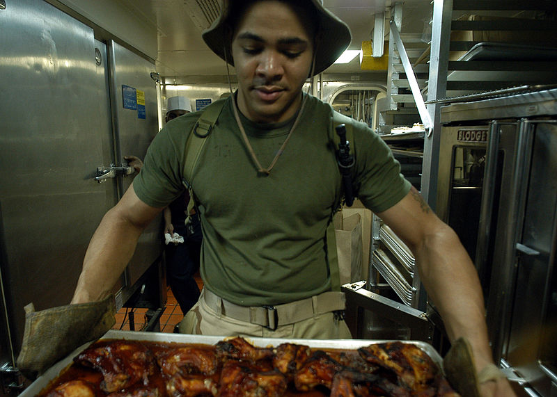 File:US Navy 030309-N-0068T-039 Cpl. Erik Battlel prepares over 50 pounds of BBQ chicken for the evening meal in the Chief petty officer mess aboard USS Kearsarge (LHD 3).jpg