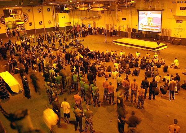 Sailors watching Super Bowl XXXVIII in the hangar bay aboard USS John F. Kennedy (CV-67)