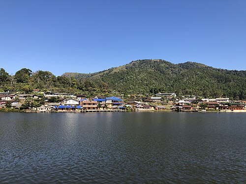 Village of Ban Rak Thai, Thailand with Khuean Nai Mok Reservoir and hills in the back.