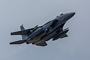 An F-15E Strike Eagle, tail number 91-0320, taking off from RAF Lakenheath in England. The aircraft is assigned to the 494th Fighter Squadron.