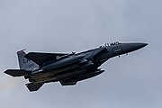 An F-15E Strike Eagle, tail number 91-0320, taking off from RAF Lakenheath in England. The aircraft is assigned to the 494th Fighter Squadron.