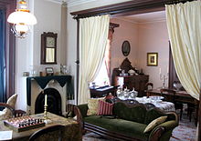 A portion of Melville House's parlour, restored to the Victorian era style maintained by the Bells, using many of their original furnishings and artifacts, including their melodeon, seen in front of the window at centre (2009). Alexander Graham Bell in Brantford, Ontario, Canada -the Bell Homestead, the Bell Family's first home in Canada, now preserved as a museum to A.G. Bell IMG 0447.JPG