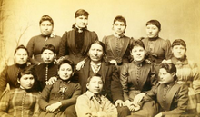 American Horse at Carlisle, 1882, with his daughter Maggie Stands Looking with other Indian students and teachers. Maggie Stands Looking was one of Captain Pratt's model students. American Horse at Carlisle, 1882.png